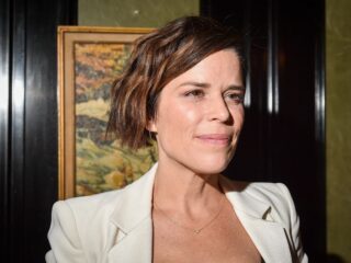 Beautiful smiling Neve Campbell being interviewed.